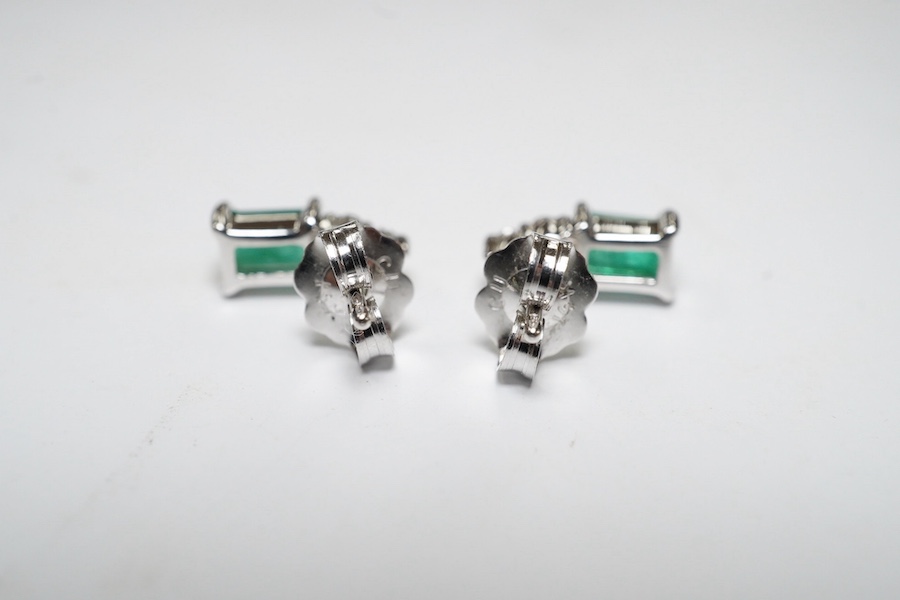 A small modern pair of 14k white metal, emerald and diamond cluster set ear studs, 9mm, gross weight 1.4 grams. Condition - good